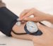 FAA Aviation Medical Examiner checking a pilot's blood pressure during an FAA medical examination