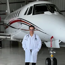 Dr. Phanor Calle, Senior FAA Aviation Medical Examiner, standing in front of a private jet for FAA aviation medical exams in Weston, Florida.