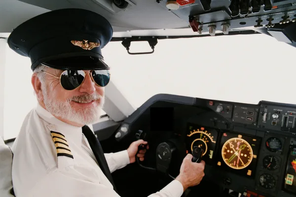 Airline pilot in a cockpit preparing for a Second Class or Third Class FAA flight physical examination at Weston Medical Clinic.